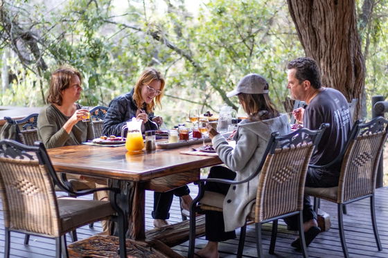 Family enjoying a meal at Shimungwe Lodge, Thornybush Game Reserve, Greater Kruger Family enjoying a meal at Shimungwe Lodge, Thornybush Game Reserve, Greater Kruger