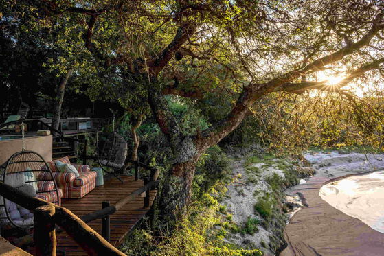 Shimungwe Lodge deck overlooking the Timbavati river in the Greater Kruger at sunset Shimungwe Lodge deck overlooking the Timbavati river in the Greater Kruger at sunset