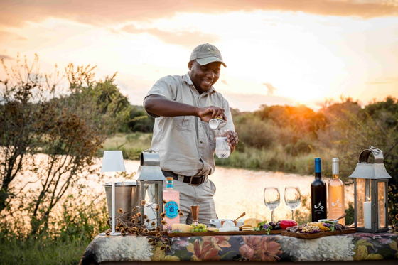 Pouring sundowner drinks, Shimungwe Lodge, Greater Kruger Park Pouring sundowner drinks, Shimungwe Lodge, Greater Kruger Park