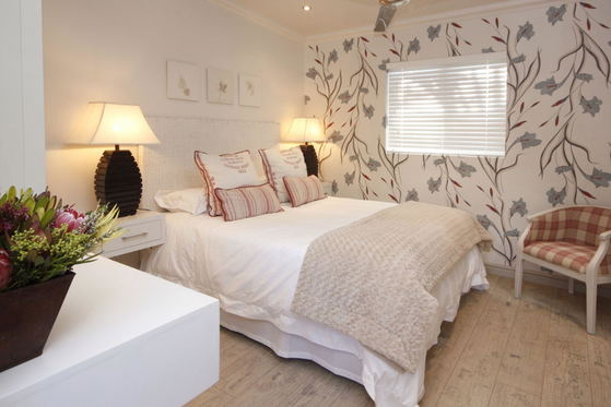 Standard Room with ensuite shower, DSTV, WIFI, tea/coffee making facilities, wall heater, ceiling fan, hot water bottles, safety deposit box, artistic hand painted walls.