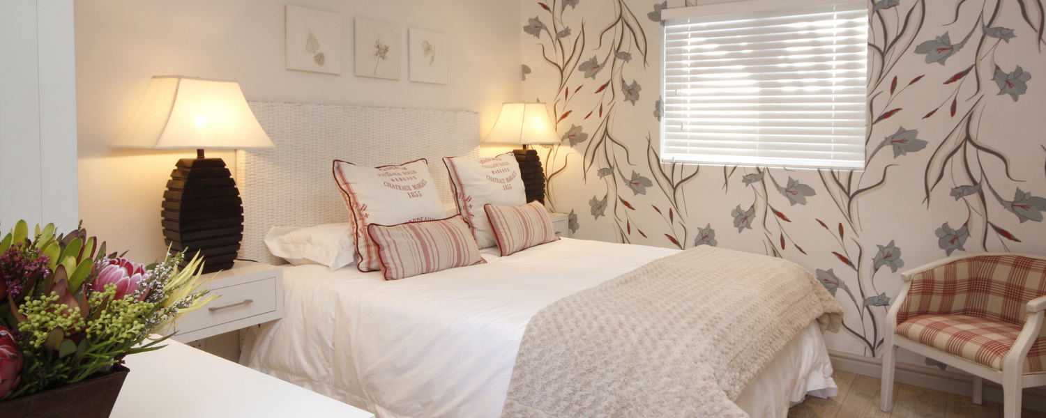 Standard Room with ensuite shower, DSTV, WIFI, tea/coffee making facilities, wall heater, ceiling fan, hot water bottles, safety deposit box, artistic hand painted walls.