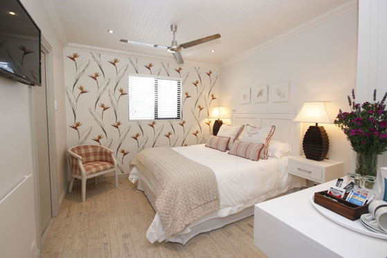Standard Room with ensuite shower, DSTV, WIFI, tea/coffee making facilities, wall heater, ceiling fan, hot water bottles, safety deposit box, artistic hand painted walls.