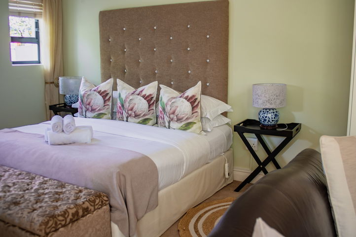 Protea Patterned Throw pillows on a Double-bed, Hermanus Cliff Path Lodge, Lodge on the Green, DCC Hotel Group
