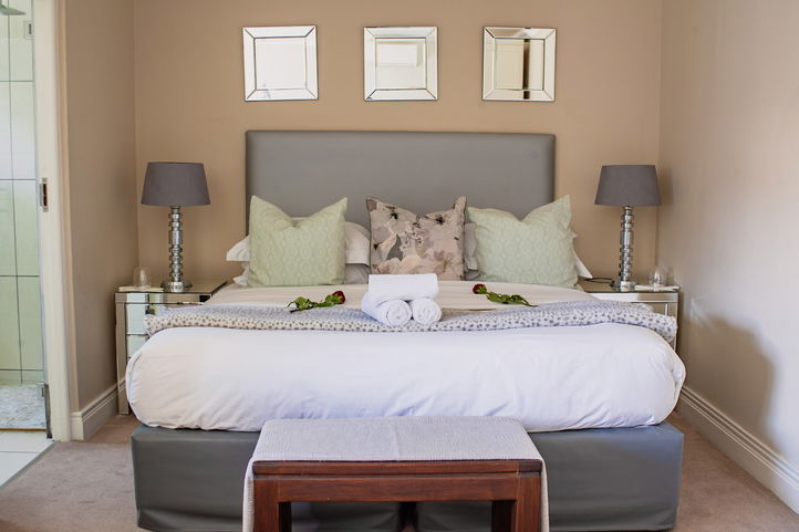 Roses on a well made up bed, Hermanus Cliff Path Lodge, Beachfront Lodge, DCC Hotel Group