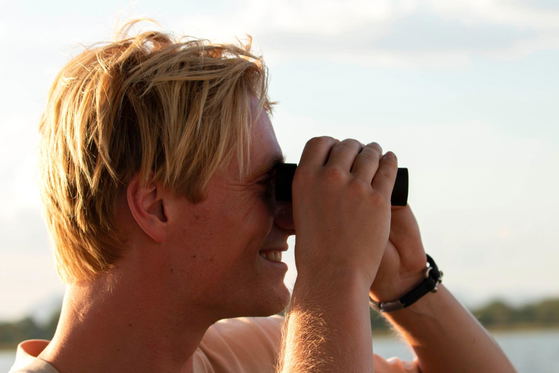 Tourist watching birds Tourist watching birds
