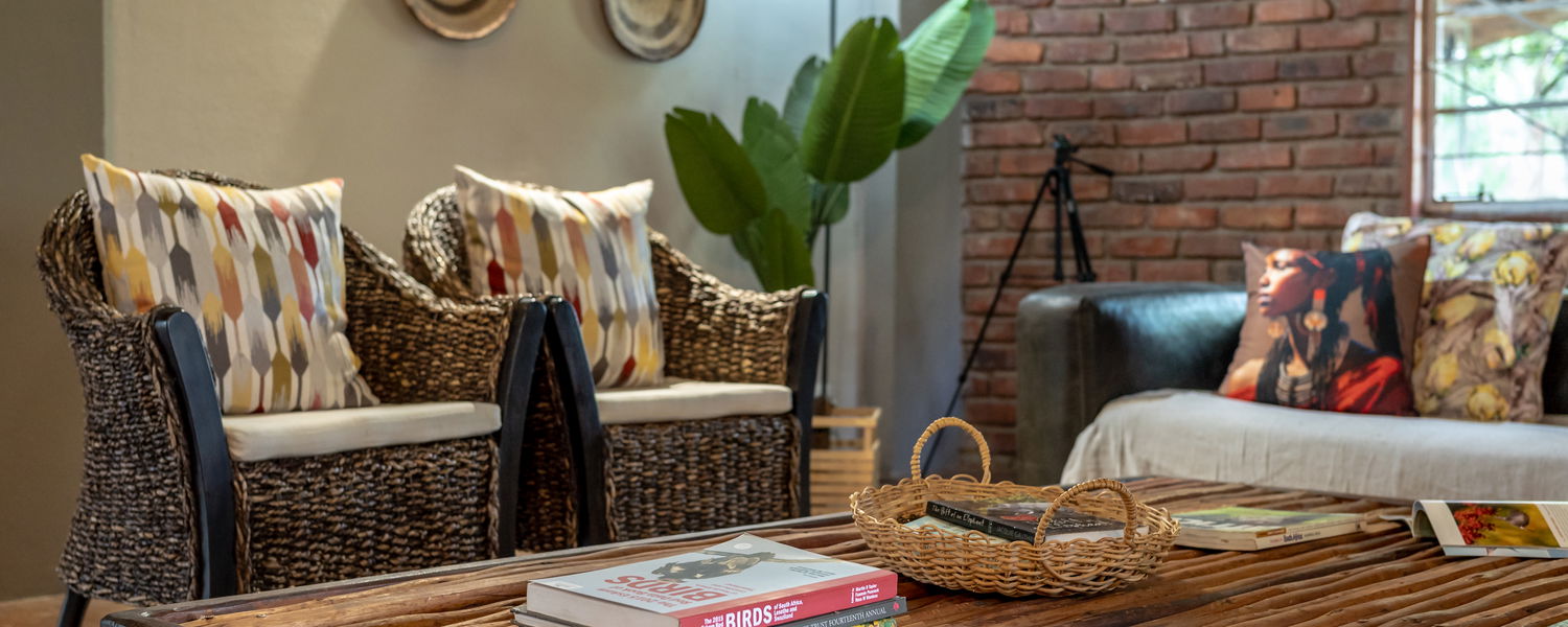 Comfortable lounge area at Ngoma Bush Lodge with rustic decor and views of the surrounding bushveld.
