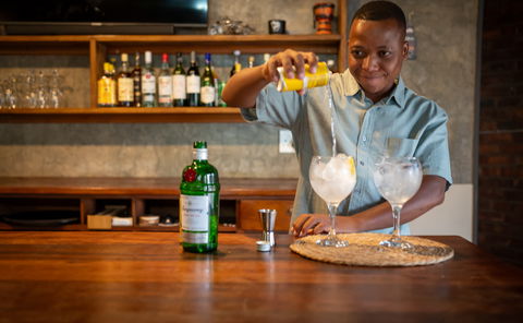 Open-plan safari lodge lounge, bar, and dining area at Ngoma Bush Lodge with views of the African bush.