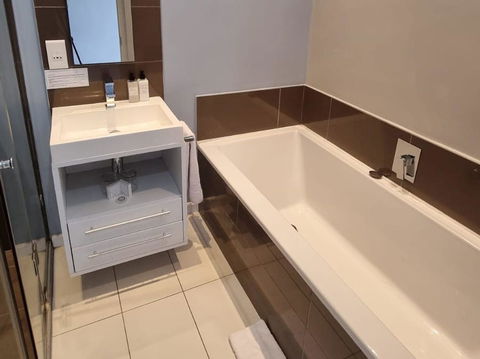 Refresh and unwind in our elegantly designed tiled bathrooms, offering a sleek and modern ambiance. Enjoy premium comfort at Hermanus Luxury Accommodation by DCC Hotel Group.