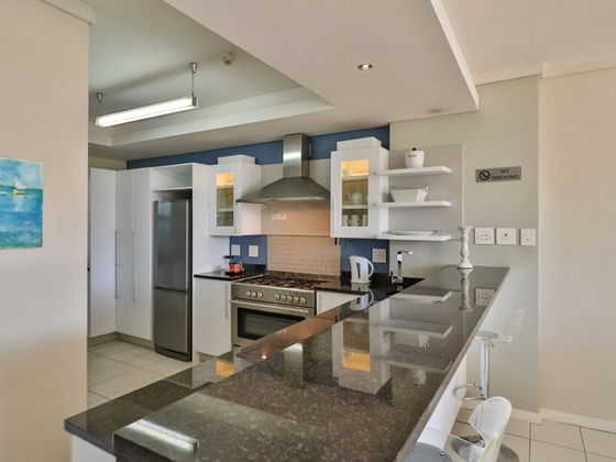 Enjoy the elegance of our beautiful kitchen, featuring a sleek marble countertop that adds a touch of luxury and sophistication to your stay at Hermanus Luxury Accommodation by The DCC Hotel Group.