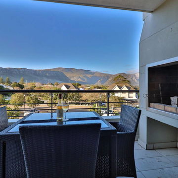 Savor breathtaking mountain views while cooking on the outdoor braai from your private balcony. Experience the perfect blend of luxury and nature at Hermanus Luxury Accommodation by DCC Hotel Group.