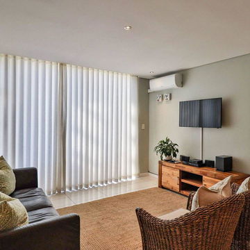 Unwind in the stylish living rooms of our luxury apartments in Hermanus, featuring plush seating and a modern entertainment setup. Experience premium comfort at DCC Hotel Group’s Hermanus Luxury Accommodation.