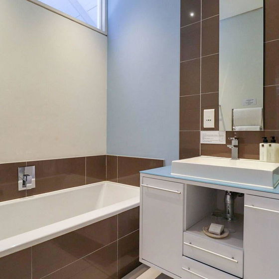 Experience spa-like relaxation in our stylish, fully tiled bathrooms, featuring contemporary finishes for a luxurious stay at Hermanus Luxury Accommodation, DCC Hotel Group.