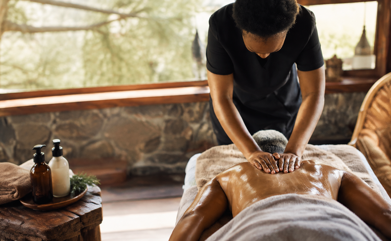Relaxing massage treatment in the open-air Bush Spa at Baluleni Safari Lodge, surrounded by the African wilderness.