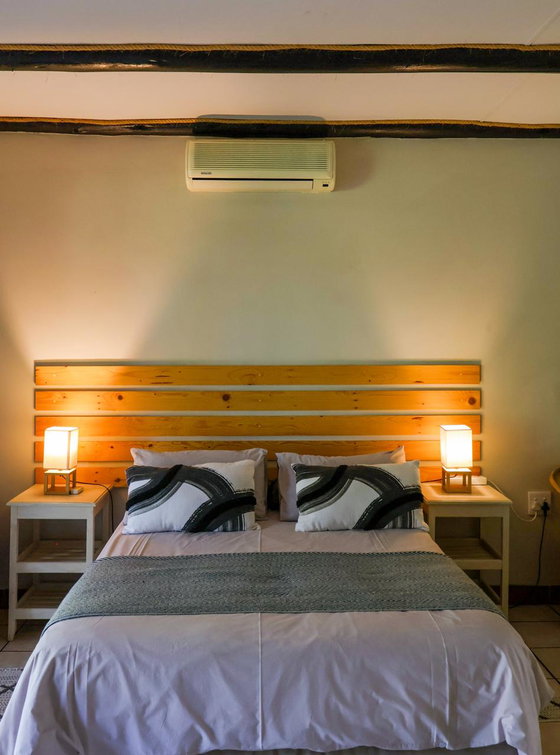 Private air-conditioned bedroom with quality bedding for a peaceful stay near Kruger National Park.