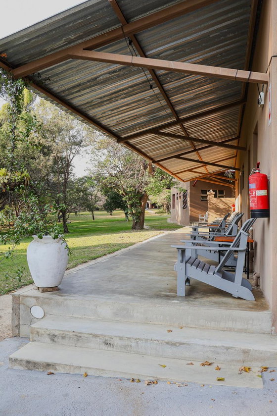 Comfortable veranda overlooking the gardens, perfect for relaxing during your stay near Kruger.