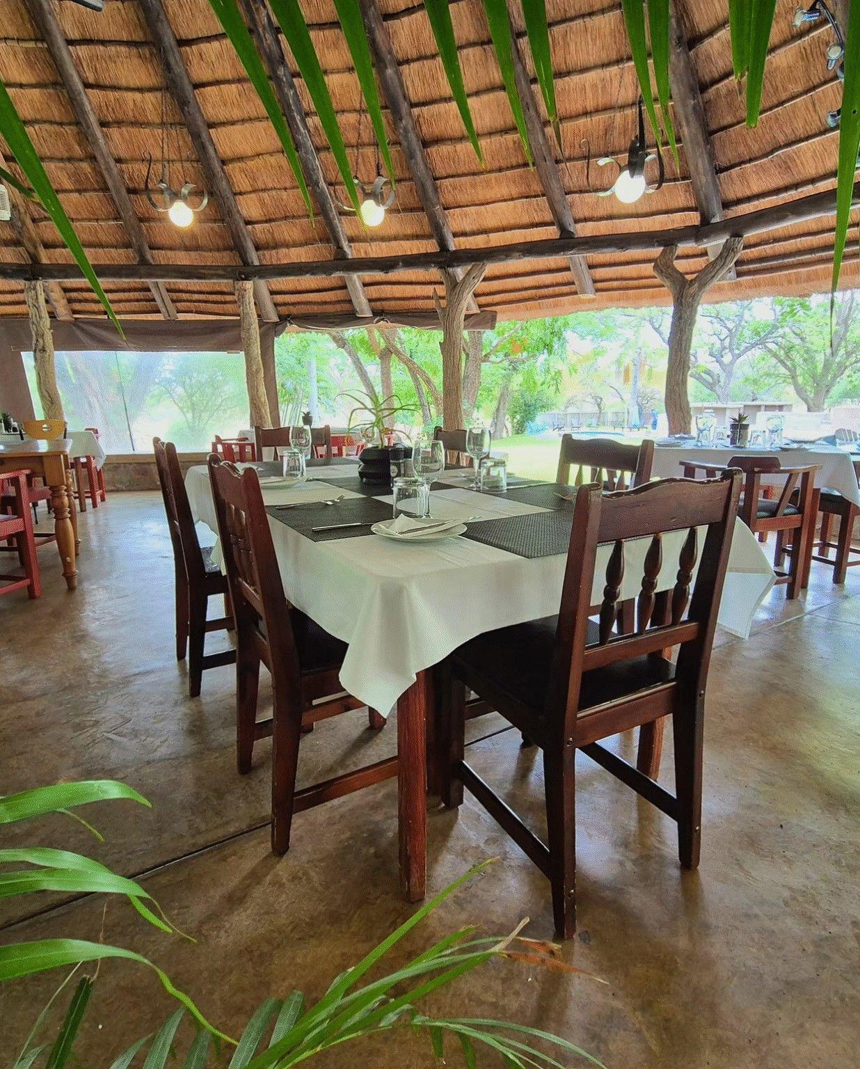 Open thatched dining area where guests enjoy breakfasts, dinners and relaxed home-style meals.