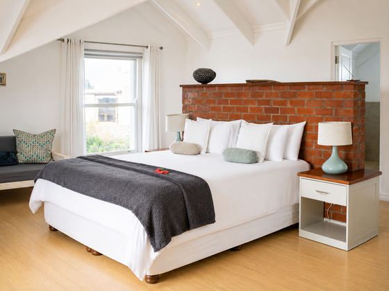 Main bedroom with en-suite bathroom upstairs at Elevate Grotto Bay