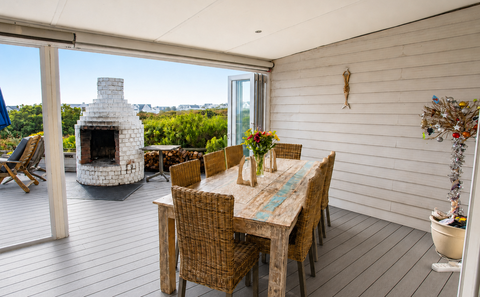 Dining table set on the veranda at Elevate Grotto Bay