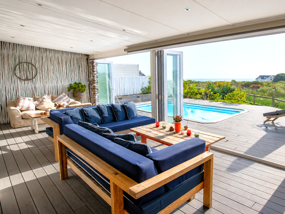 Elevate Grotto Bay — veranda with two lounges overlooking the pool