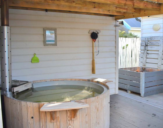 Front of house with the hot tub and firewood store