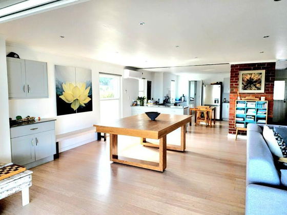 Open-plan lounge and kitchen area at Elevate Grotto Bay