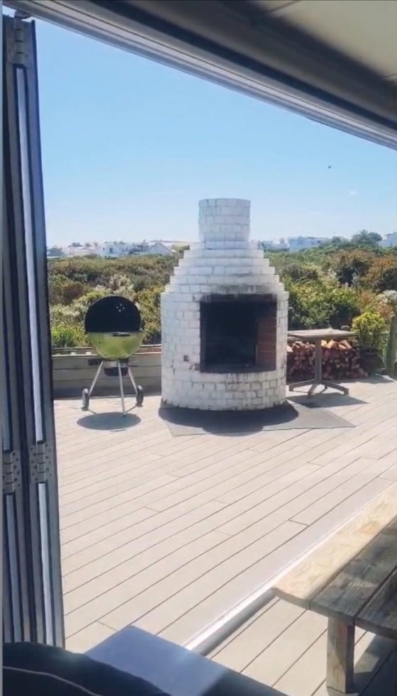 Outdoor braai and fireplace area at Elevate Grotto Bay