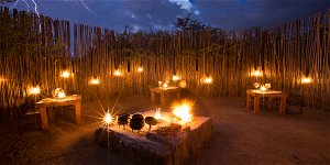 Ngama Tented Safari Lodge outside dining restaurant, the boma. Fire, Lanterns and the night's sky