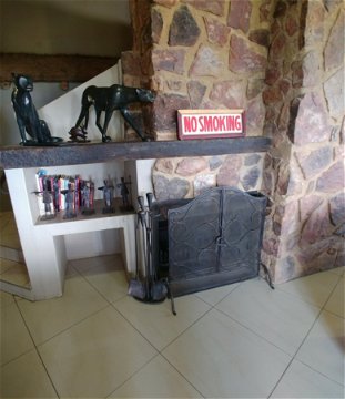 Blue Sky Lodge - Big stone fireplace in lounge. 2 of the bedrooms also have private fireplaces