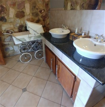 Red Sky Lodge - Lower west bathroom with antique pram