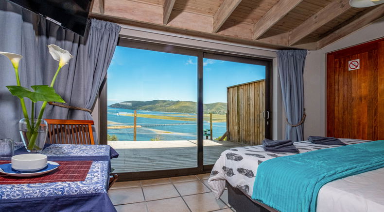 Stunning view over Knysna lagoon, harbor and heads from the extra length king size bed bed Stunning view over Knysna lagoon, harbor and heads from the extra length king size bed bed