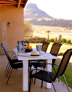 Mongoose Self Catering Cottage on the Clocolan Ficksburg border Eastern Free State, dining Al Fresco with the view of the mountain behind.