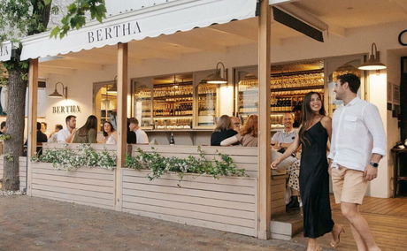 Couple walking past Bertha Wine Bar in Stellenbosch, where locals and visitors enjoy boutique wines, modern interiors, and a buzzing atmosphere just steps from Bonne Esperance Guest House. Couple walking past Bertha Wine Bar in Stellenbosch, where locals and visitors enjoy boutique wines, modern interiors, and a buzzing atmosphere just steps from Bonne Esperance Guest House.