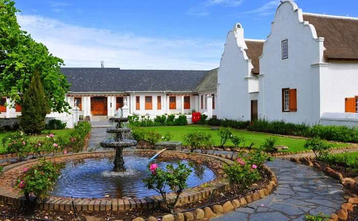 Stellenbosch Village Museum courtyard with Cape Dutch architecture and a central garden fountain — a top cultural attraction in Stellenbosch.