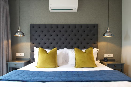Button headboard, Chartreuse pillows, modern bedroom, grey interiors