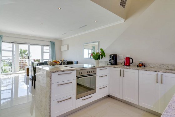 Self catering kitchen leads onto the open plan living area and balcony.