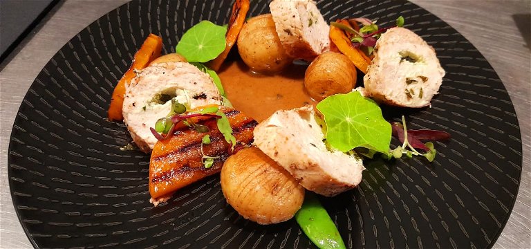 Spinach and Goats Cheese Stuffed Chicken Breast, Hasselback Potatoes, Roasted Butternut, Mange Tout and a Peppercorn Sauce 
