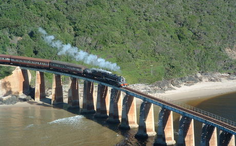 Image: Tim Giddings - public domain. Outeniqua Choo Tjoe on the Kaaimans River Bridge. Photo taken some time before the line was shut down in 2006.