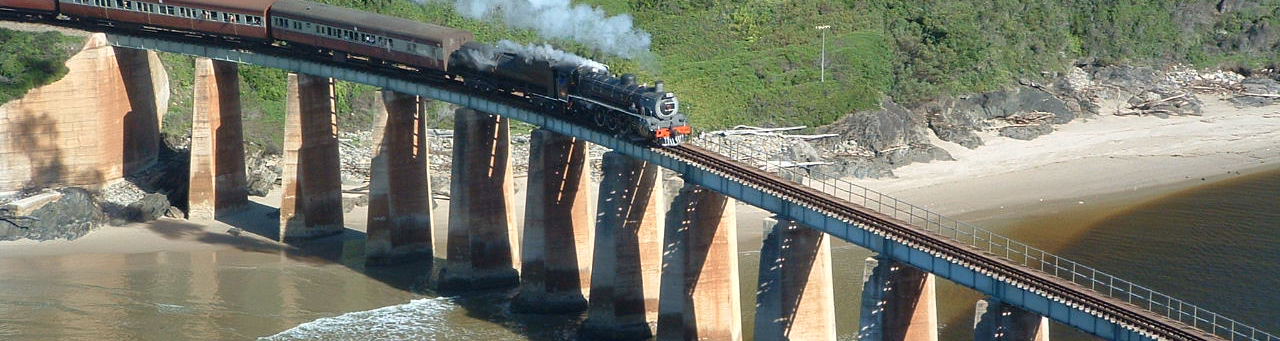 Image: Tim Giddings - public domain. Outeniqua Choo Tjoe on the Kaaimans River Bridge. Photo taken some time before the line was shut down in 2006.