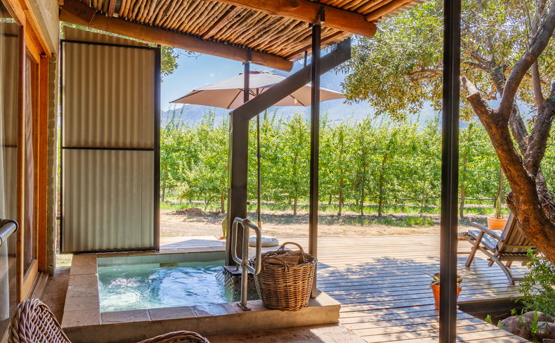 Private wood-fired hot tub on a timber deck overlooking a lush fruit orchard in the Witzenberg Valley Private wood-fired hot tub on a timber deck overlooking a lush fruit orchard in the Witzenberg Valley