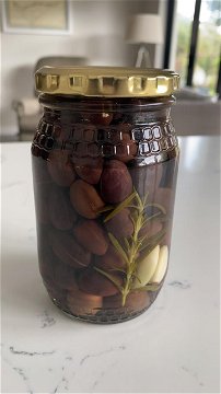 Olives in a jar with garlic, after 5 weeks in salt water