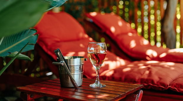 Glass of wine near the pool Glass of wine near the pool