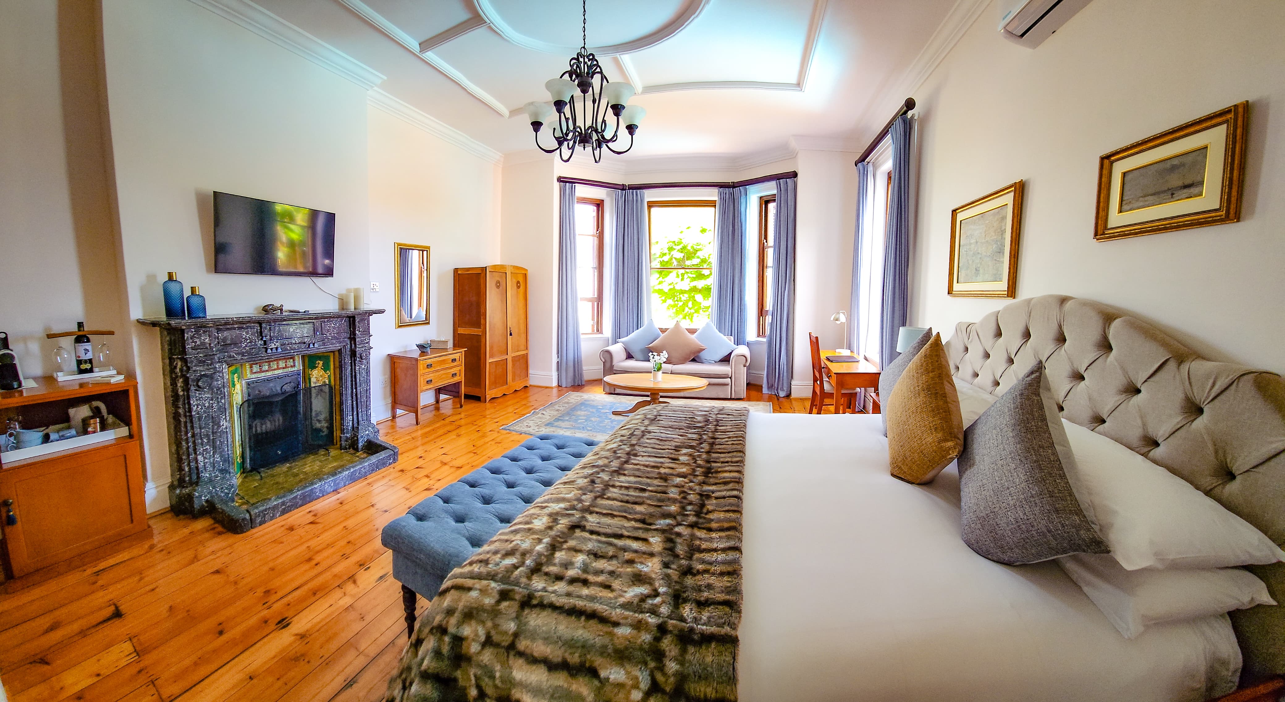 The room features an extra-long king-size bed that can be converted into two single beds on request, along with a comfortable double sleeper couch and an optional baby cot. Ideal for families of up to five sharing.