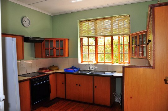 Large kitchen with stove, oven, dishwasher, fridge-freezer. View from kitchen is over garden.