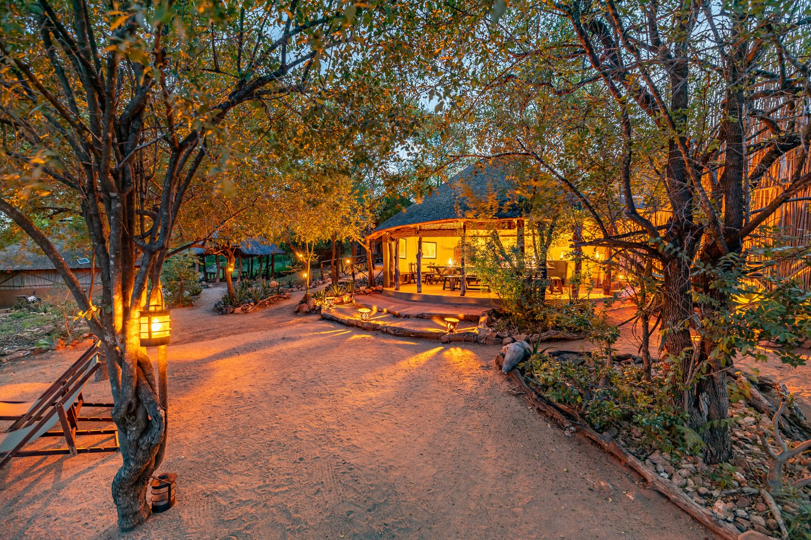 Umlani Bushcamp lantern-lit at dusk in the Timbavati