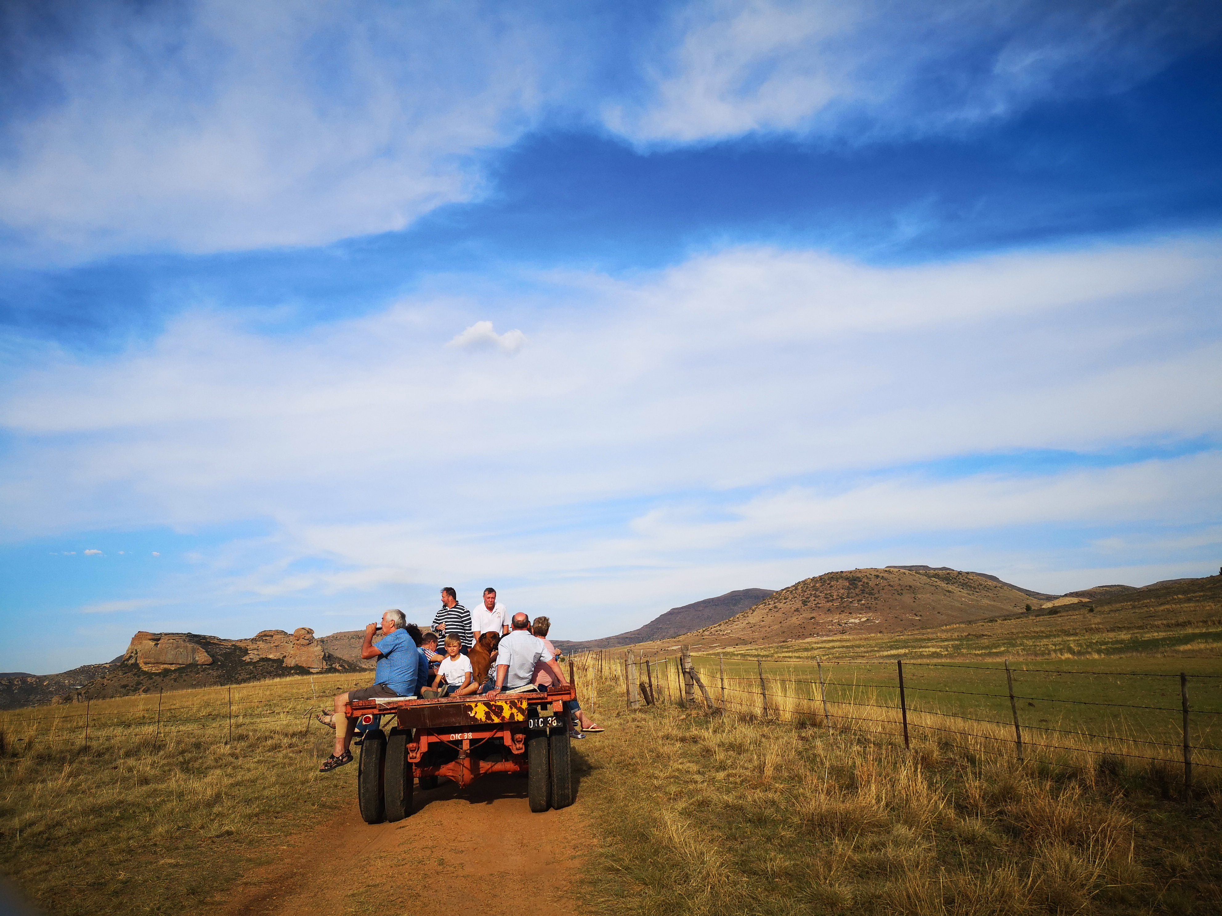 Guests enjoy a sundowner trip up the mountain on a tractor and trailor 