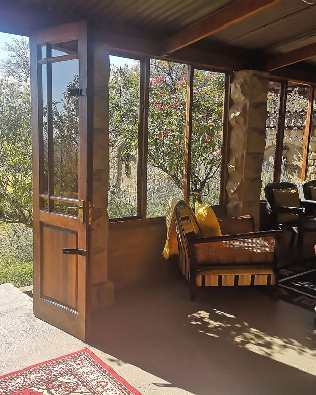 Covered patio with build-in barbeque/fireplace and views on the mountains and fountain in the garden Covered patio with build-in barbeque/fireplace and views on the mountains and fountain in the garden