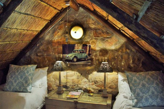Thatch roof,sandstone walls,cosy bedroom in loft