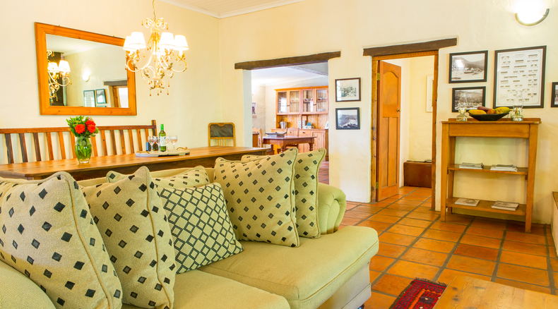 The living room and open plan dining area in the Farmhous at Bonnievale River Lodge The living room and open plan dining area in the Farmhous at Bonnievale River Lodge