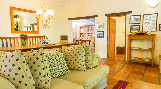 The living room and open plan dining area in the Farmhous at Bonnievale River Lodge The living room and open plan dining area in the Farmhous at Bonnievale River Lodge