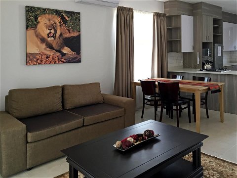 Apartments @ 125 - 2 bedroom unit; lounge & dining area, equipped with smart enabled TV